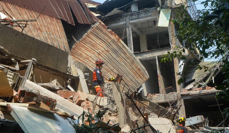 Rescue workers search for survivors trapped in a damaged building in New Taipei City, after a major earthquake hit Taiwan's east